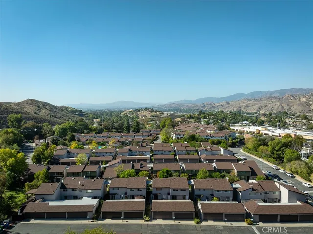 an aerial view of residential house with parking and mountain view
