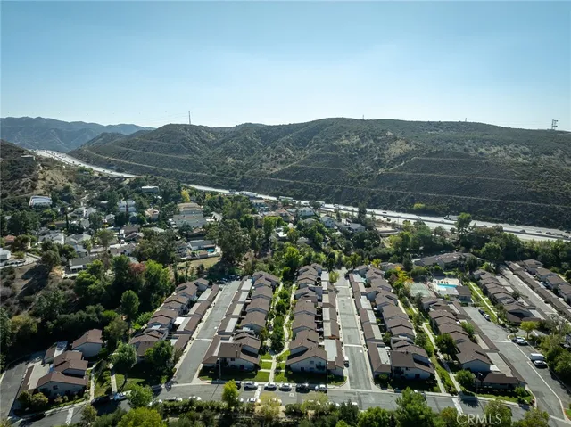 an aerial view of residential houses with city view