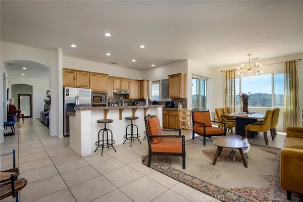 a living room with lots of furniture and kitchen view