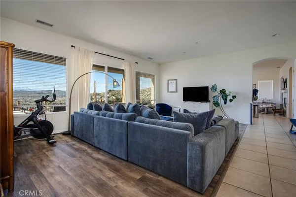 a living room with furniture a couch and a flat screen tv