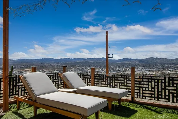 a view of a balcony with table and chairs