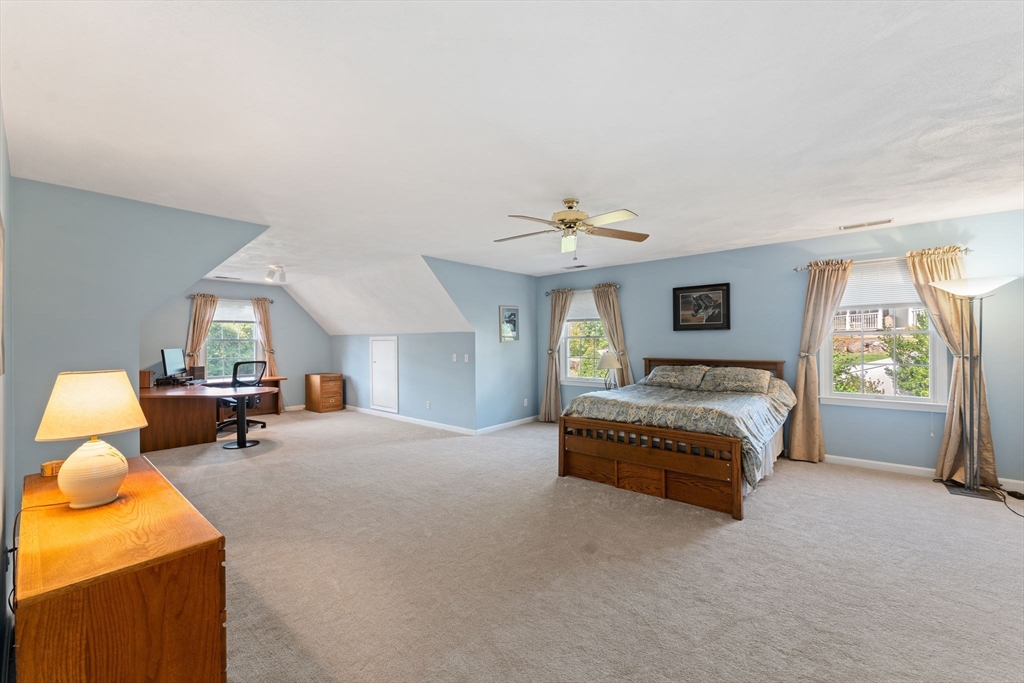 5 Spring House Lane Cumberland, RI 02864 - Photo 12 of 34 a spacious bedroom with a bed and window