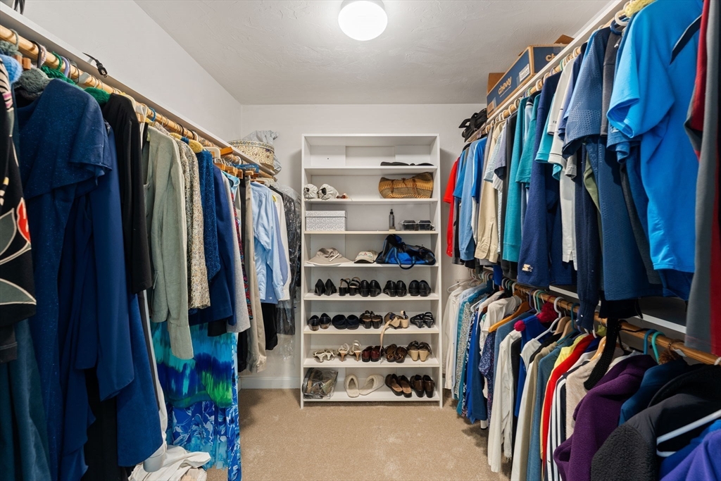 5 Spring House Lane Cumberland, RI 02864 - Photo 14 of 34 a view of walk in closet with clothes and shoes