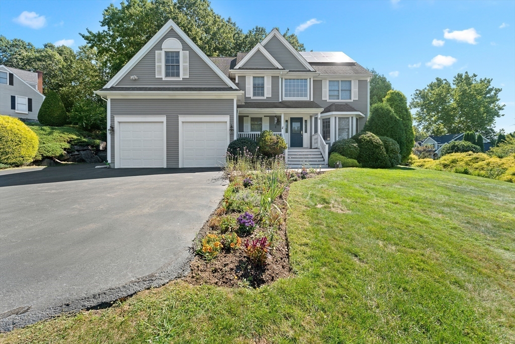 5 Spring House Lane Cumberland, RI 02864 - Photo 28 of 34 a front view of a house with a yard and garage