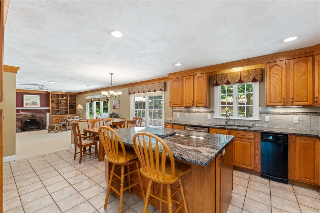 5 Spring House Lane Cumberland, RI 02864 - Photo 5 of 34 a kitchen with stainless steel appliances granite countertop table chairs sink and cabinets