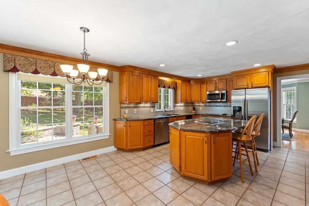 5 Spring House Lane Cumberland, RI 02864 - Photo 6 of 34 a kitchen with stainless steel appliances granite countertop a stove a sink and a refrigerator