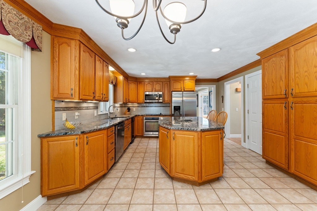 5 Spring House Lane Cumberland, RI 02864 - Photo 7 of 34 a kitchen with stainless steel appliances granite countertop a stove a sink dishwasher and a refrigerator
