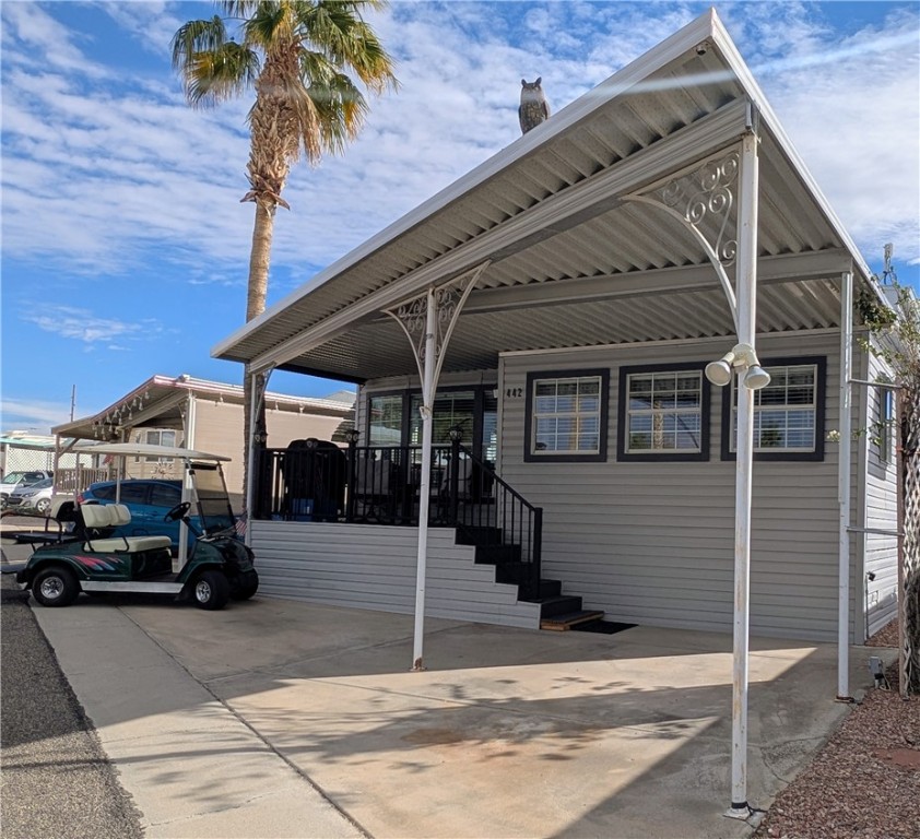 View of vehicle parking and front deck