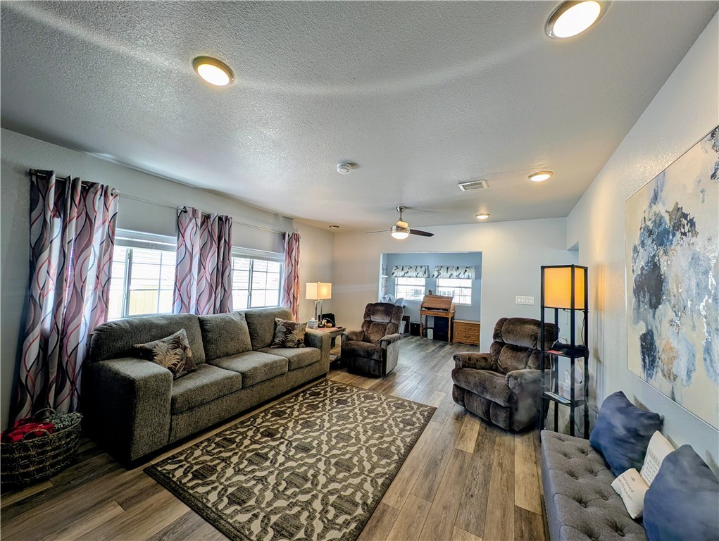 2000 Ramar Road, Unit 442 Bullhead City, AZ 86442 - Photo 14 of 28 Living area featuring wood-type flooring, ceiling fan, and a textured ceiling