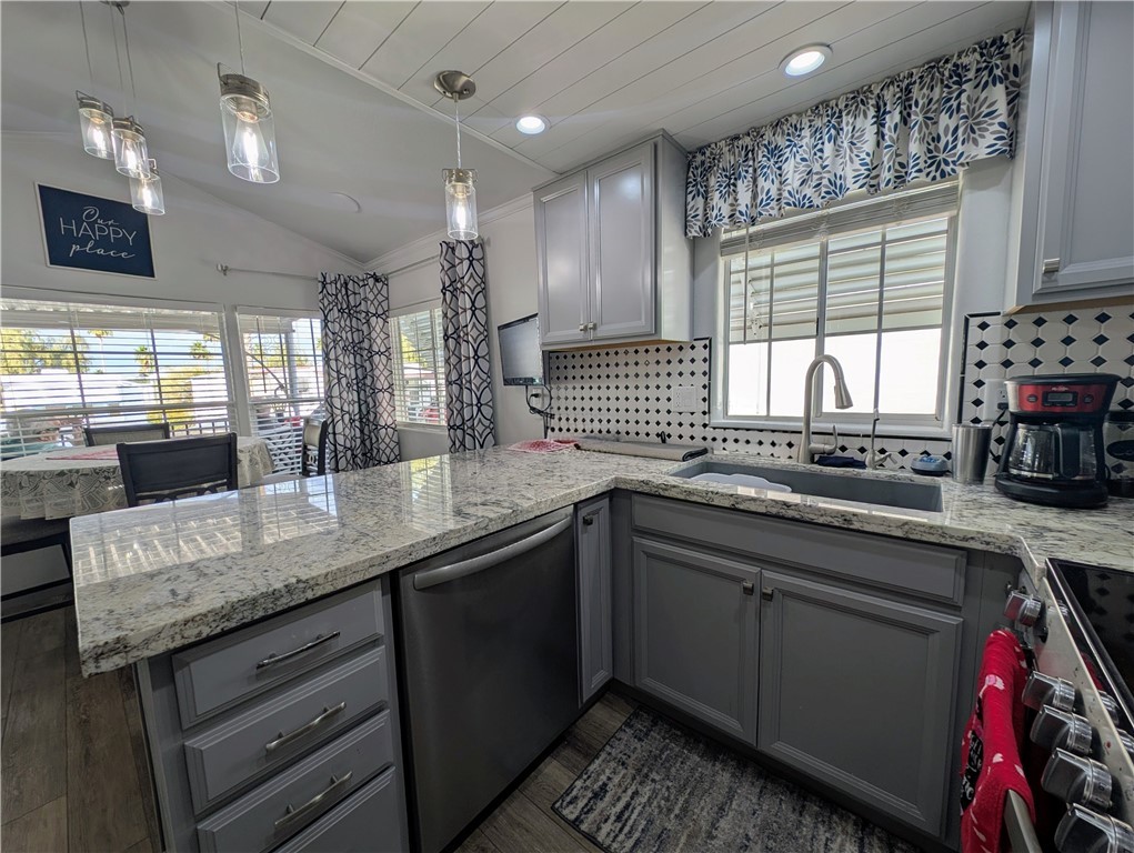 2000 Ramar Road, Unit 442 Bullhead City, AZ 86442 - Photo 16 of 28 Kitchen featuring gray cabinets, light stone countertops, backsplash, vaulted ceiling, and recessed lighting