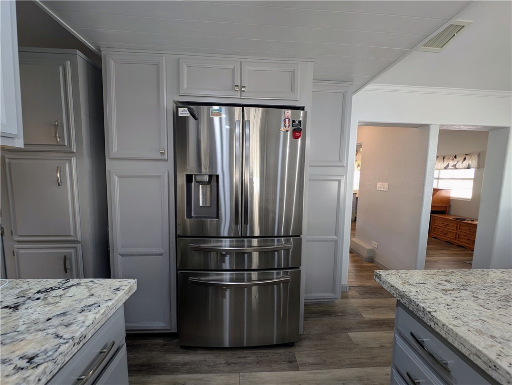 2000 Ramar Road, Unit 442 Bullhead City, AZ 86442 - Photo 17 of 28 Kitchen featuring stainless steel fridge with ice dispenser, gray cabinets, light stone countertops, light wood-style floors, and ornamental molding