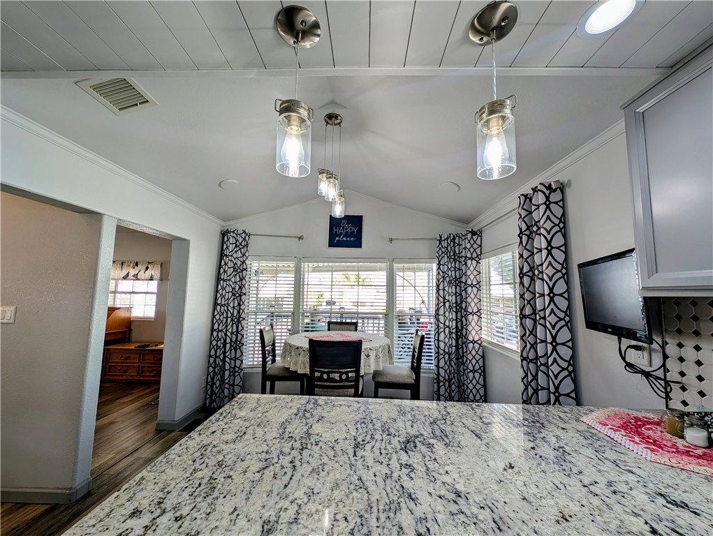 2000 Ramar Road, Unit 442 Bullhead City, AZ 86442 - Photo 18 of 28 Dining featuring lofted ceiling, crown molding, and light wood finished floors
Granite counter tops