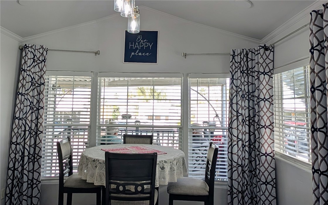 2000 Ramar Road, Unit 442 Bullhead City, AZ 86442 - Photo 19 of 28 Dining space with ornamental molding and vaulted ceiling