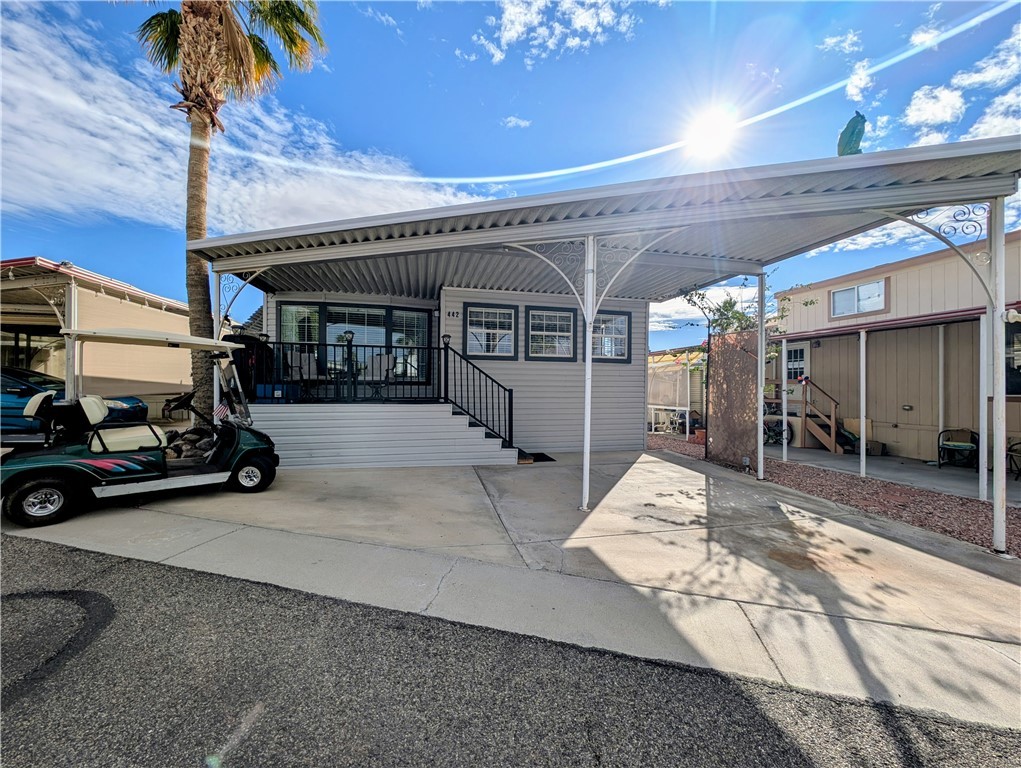 2000 Ramar Road, Unit 442 Bullhead City, AZ 86442 - Photo 2 of 28 View of vehicle parking featuring a carport