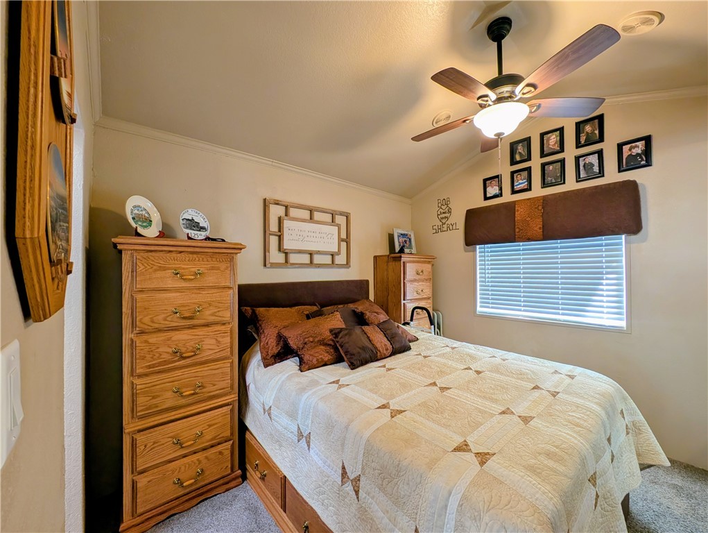 2000 Ramar Road, Unit 442 Bullhead City, AZ 86442 - Photo 21 of 28 Carpeted bedroom featuring ornamental molding, vaulted ceiling, and ceiling fan