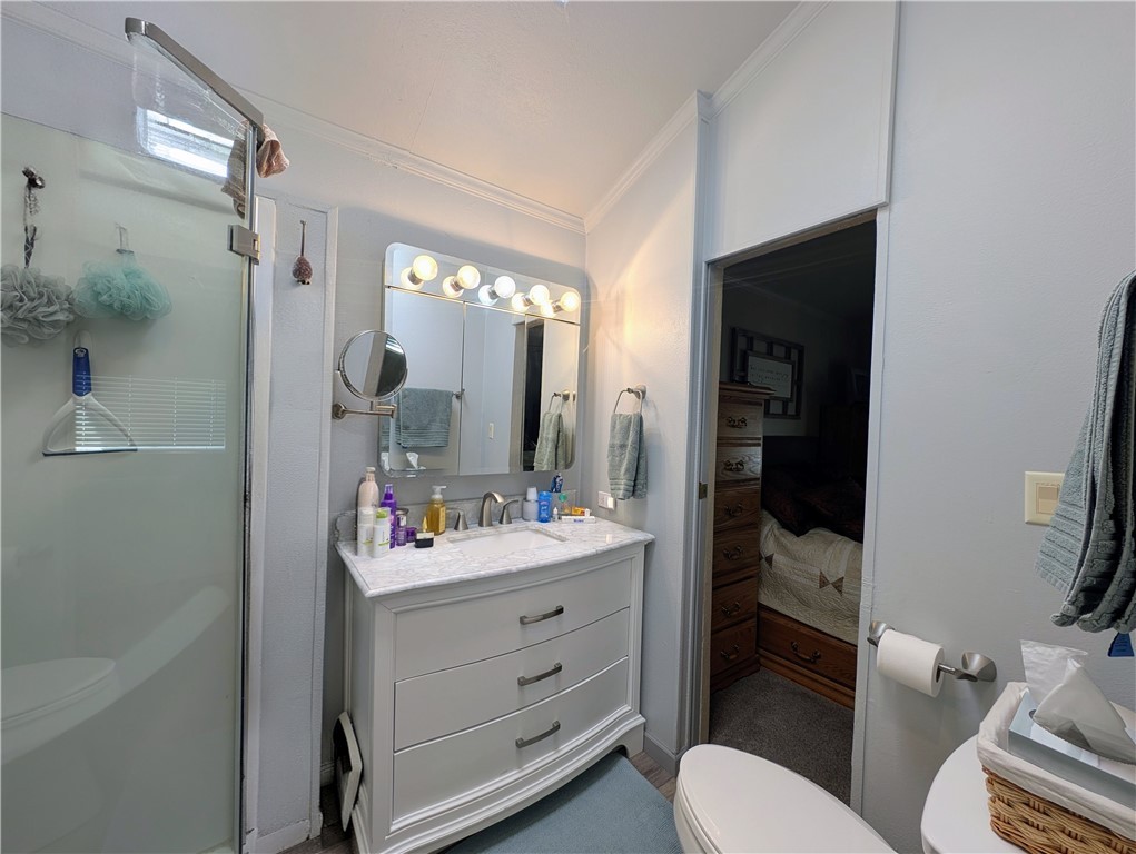 2000 Ramar Road, Unit 442 Bullhead City, AZ 86442 - Photo 25 of 28 Bathroom featuring vanity, a stall shower, and ornamental molding