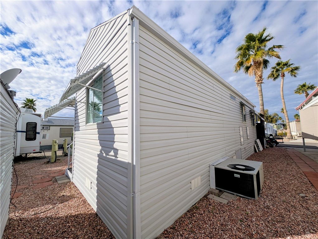 2000 Ramar Road, Unit 442 Bullhead City, AZ 86442 - Photo 6 of 28 View of home's exterior featuring a central air condition unit and crawl space