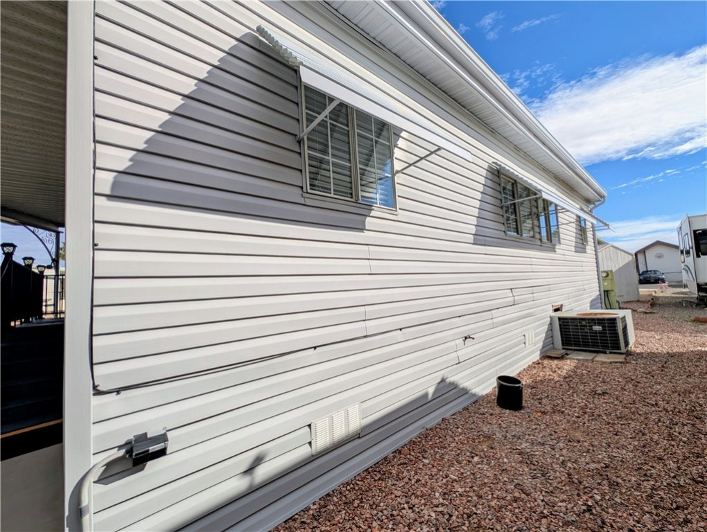 2000 Ramar Road, Unit 442 Bullhead City, AZ 86442 - Photo 8 of 28 View of property exterior with a heat pump
