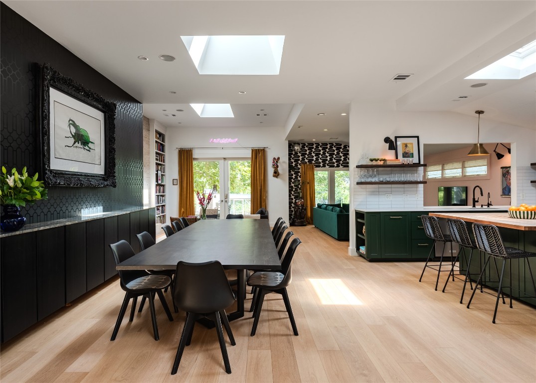 a view of a dining room with furniture and a chandelier