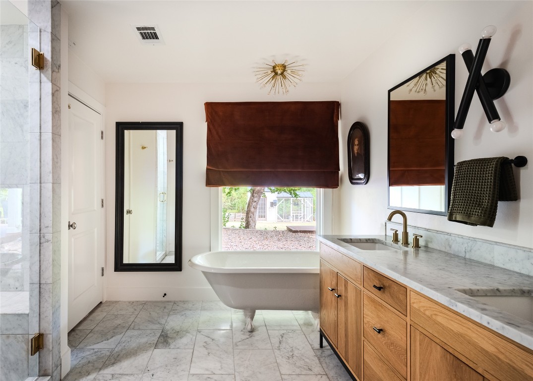 4203 Afton Lane Austin, TX 78744 - Photo 13 of 24 a bathroom with double vanity sink a bathtub and mirror