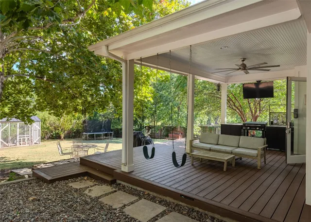 a roof deck with table and chairs