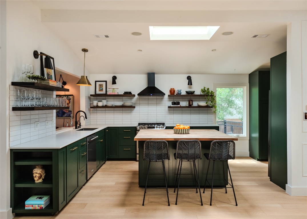 4203 Afton Lane Austin, TX 78744 - Photo 5 of 24 a kitchen with stainless steel appliances granite countertop a stove a sink dishwasher and a refrigerator
