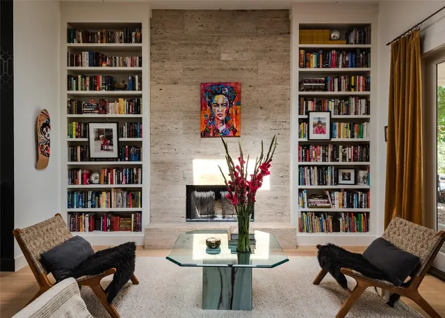 a living room with furniture and a book shelf