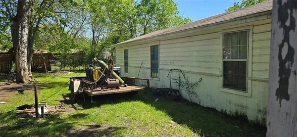 a view of a backyard with chairs and a small cabin