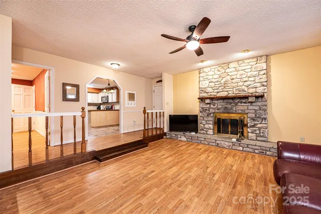 a living room with furniture fireplace and wooden floor