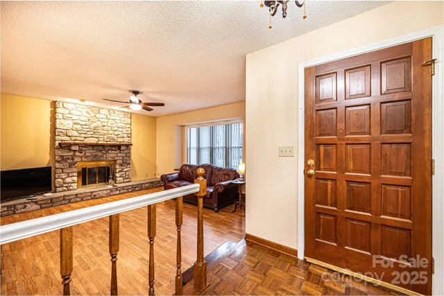 a view of a living room with furniture and large windows