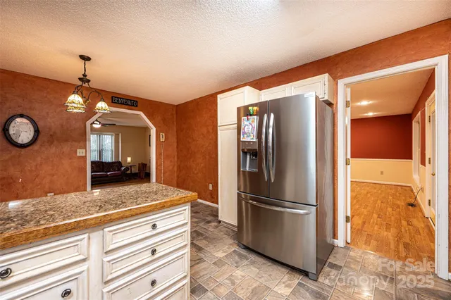 a view of a kitchen with a refrigerator cabinets and a wooden floor