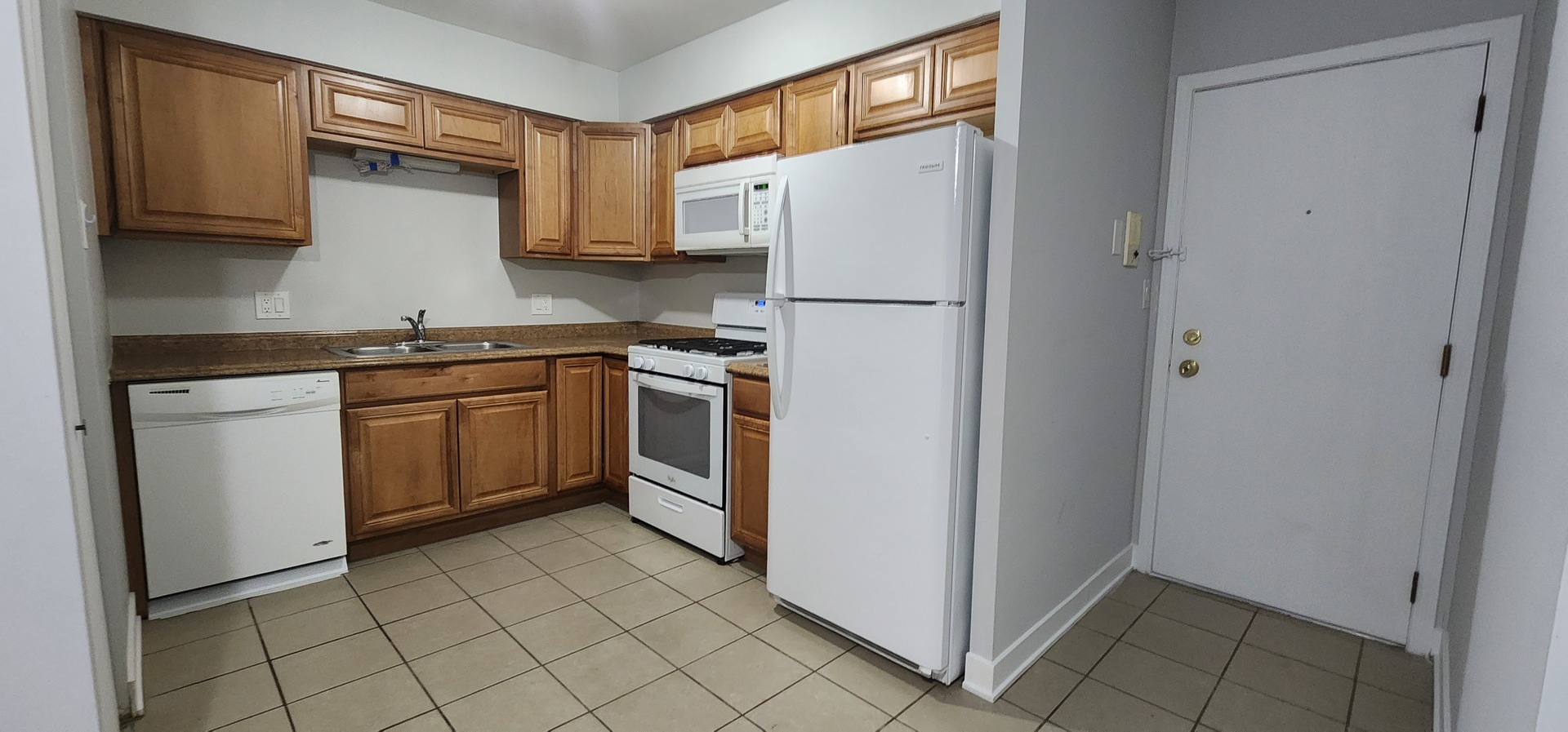 9290 Hamilton Court, Unit A Des Plaines, IL 60016 - Photo 2 of 10 a kitchen with a refrigerator sink and cabinets