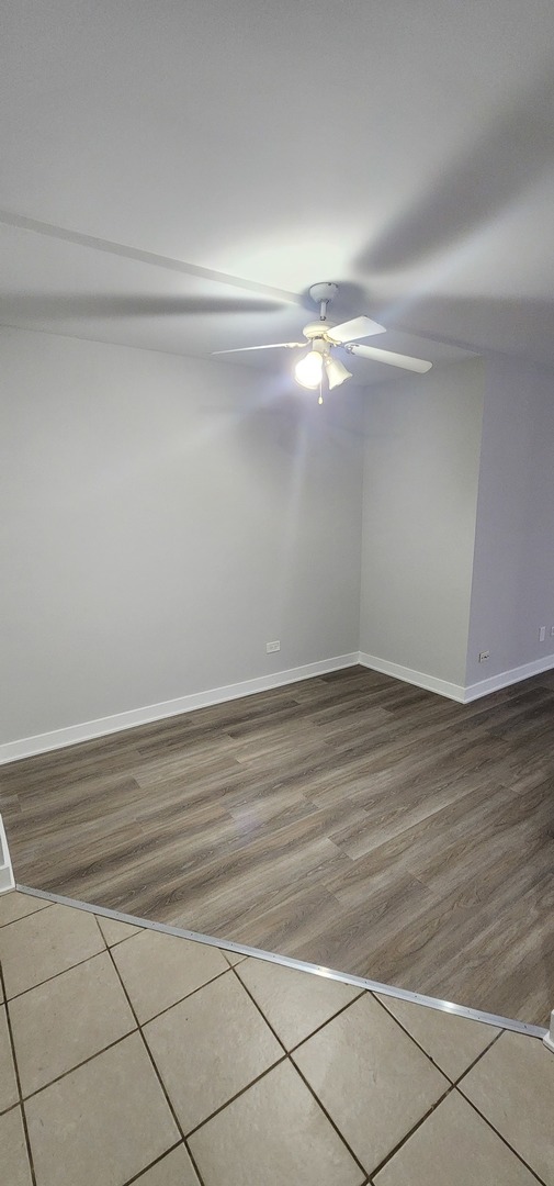 9290 Hamilton Court, Unit A Des Plaines, IL 60016 - Photo 4 of 10 a view of a room with wooden floor