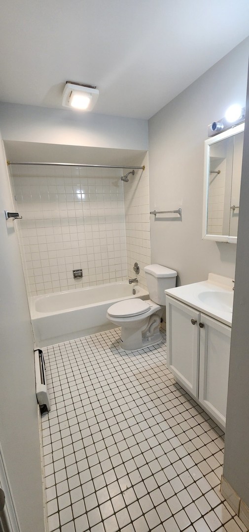 9290 Hamilton Court, Unit A Des Plaines, IL 60016 - Photo 7 of 10 a bathroom with a sink a toilet and shower