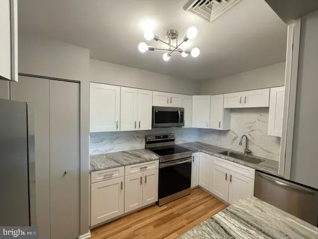 a kitchen with a sink stove and refrigerator