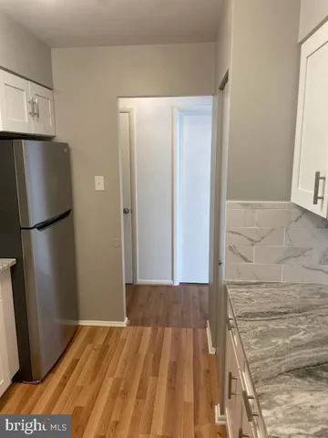 a view of a room with wooden floor and closet