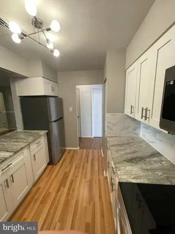 a kitchen with a sink refrigerator and microwave