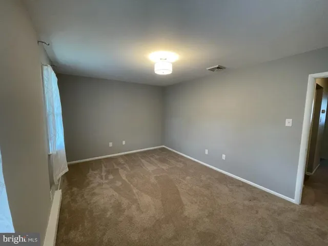 an empty room with a empty space and a window