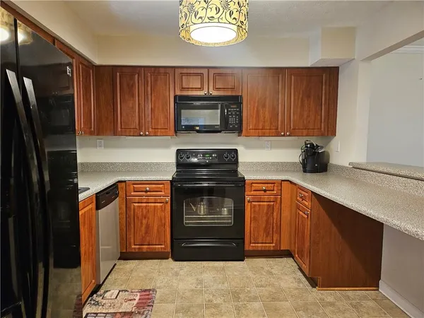 a kitchen with stainless steel appliances granite countertop a refrigerator stove and microwave