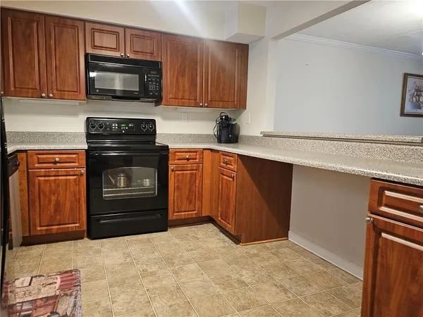 a kitchen with a stove microwave and sink