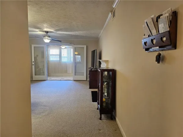 a view of a hallway with paintings on the wall