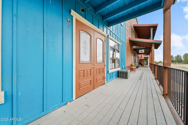 a view of a balcony with wooden floor
