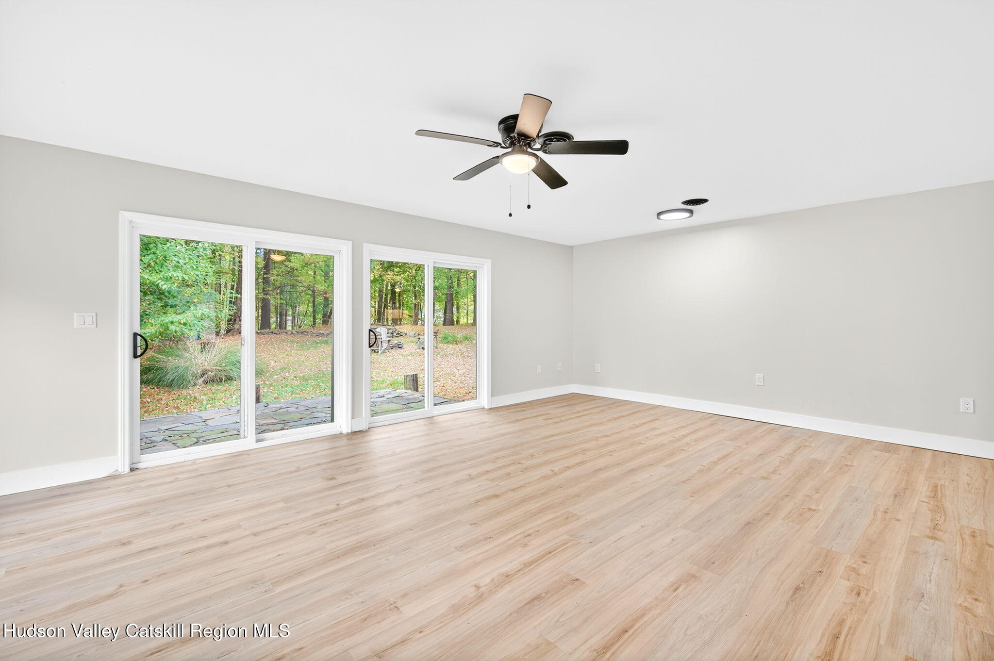 5 Lazy Brook Lane Woodstock, NY 12498 - Photo 12 of 35 a view of empty room with wooden floor and fan