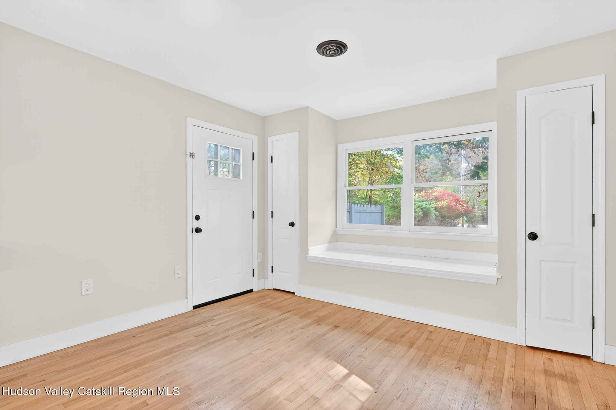 5 Lazy Brook Lane Woodstock, NY 12498 - Photo 15 of 35 a view of an empty room with a window and wooden floor
