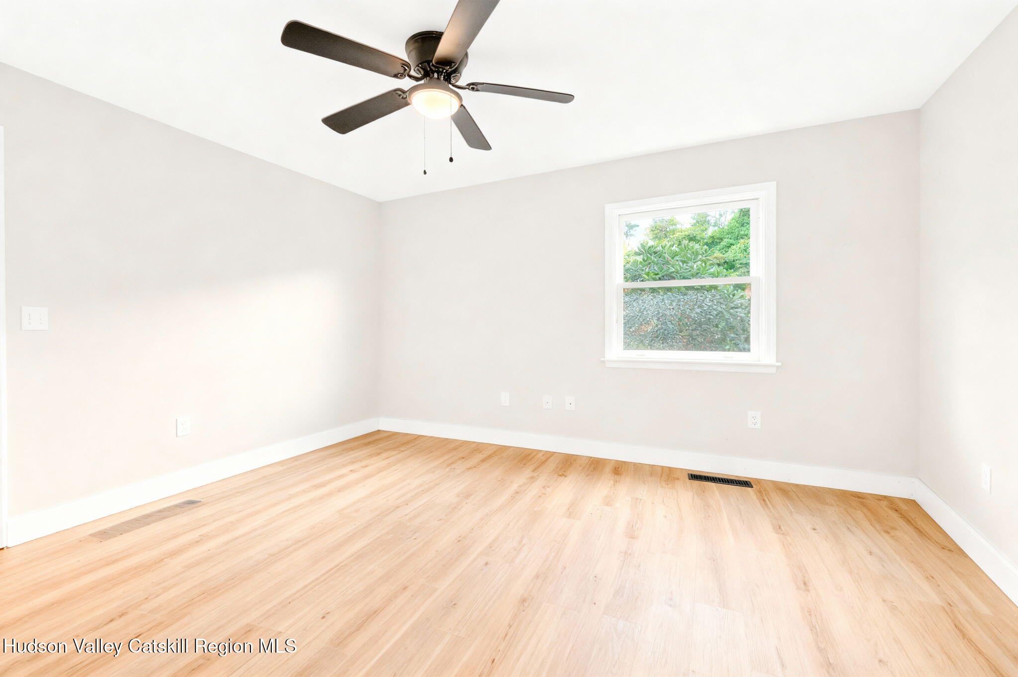 5 Lazy Brook Lane Woodstock, NY 12498 - Photo 17 of 35 an empty room with wooden floor and windows