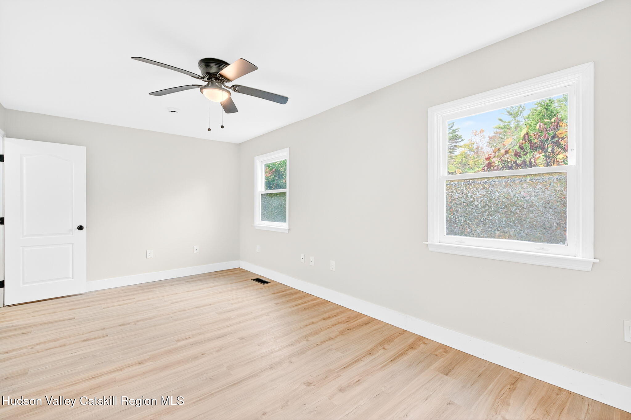 5 Lazy Brook Lane Woodstock, NY 12498 - Photo 26 of 35 a view of an empty room with wooden floor and a window