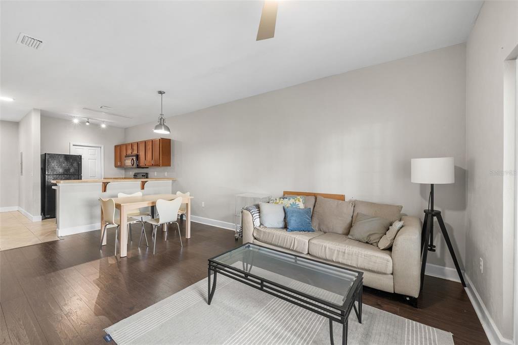 2927 Southwest 35th Place, Unit 113 Gainesville, FL 32608 - Photo 8 of 27 a living room with furniture and a table