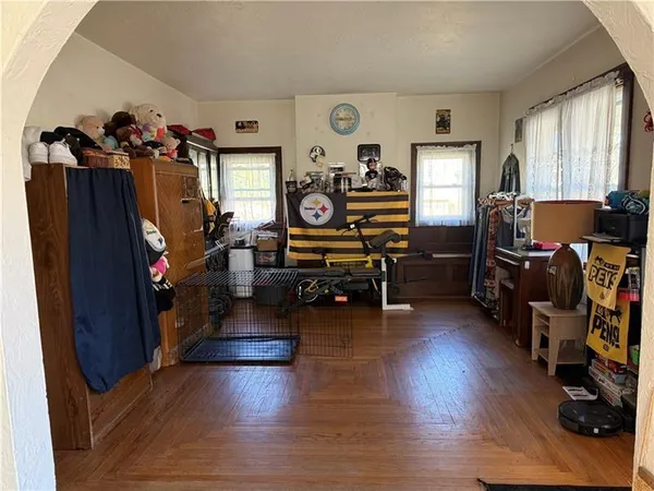 a living room with furniture and wooden floor