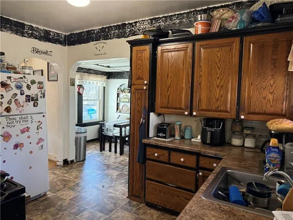 a kitchen with stainless steel appliances granite countertop a refrigerator and a stove