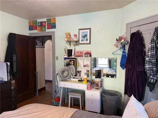 a work room with furniture a rug and a flat screen tv